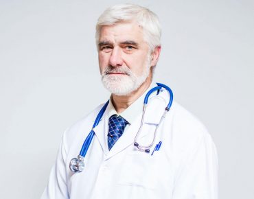 doctor-standing-with-folder-stethoscope doctor-standing-with-folder-stethoscope